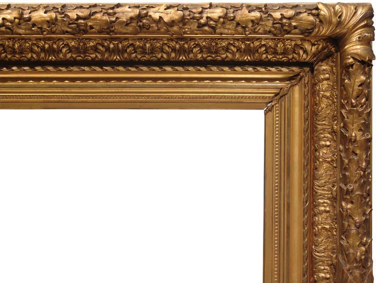 PERIOD FRAME 1880s American Barbizon painting frame; gilded cast ornament on wood; oak leaf and acorn top edge with burnished acanthus corners; acanthus cushion with larger leaf corner. 
Sight size (opening from front): 29-3/8” x 48-7/8” 
Molding