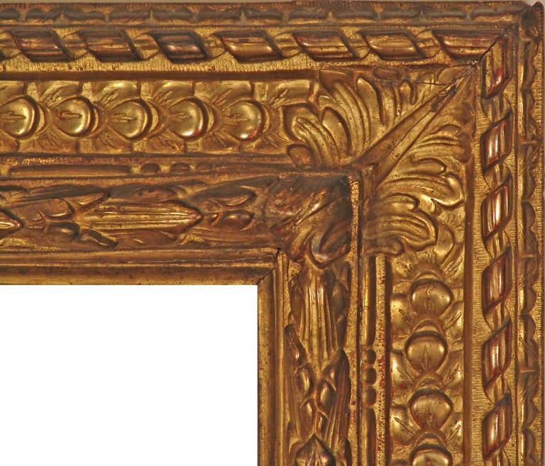 PERIOD FRAME c. 17th century Italian gilded hand-carved wood frame; reverse bolection profile, running leaf back edge, hazzled detailing, ribbon and stick  bolection with hazzled side detailing, frieze with imbrecated leaves, central rosettes,