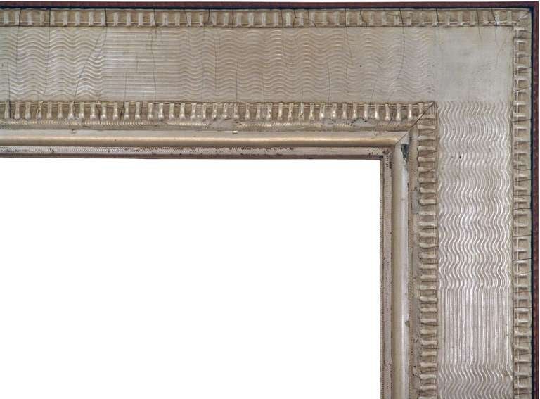 c. 1920 British Modernist Frame. Silver leaf, combed gesso, rippled wood surround, wood back.
Sight size (opening from front): 19-7/8