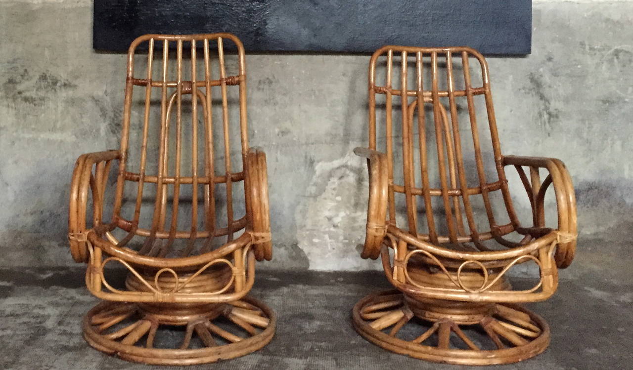 A large pair of very comfortable 1950 rattan armchairs with original cushions.

Dim = H back 102 / H seat 45 x 75 x 65 cm.