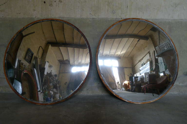One available now. 
Large original convex glass mirror with iron surround and lovely aged patina to both, circa 1930.

Diam = 123 cm x 3,8 cm