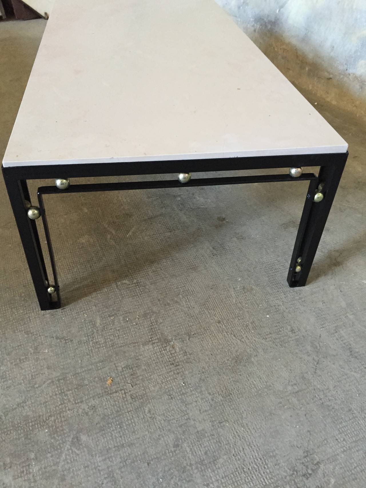 a chic 1950 low table relaquered in black ,whit stone top,a little luster on a angle and some gold balls are oxyded

Dim = 130 X 60 X 36 cm