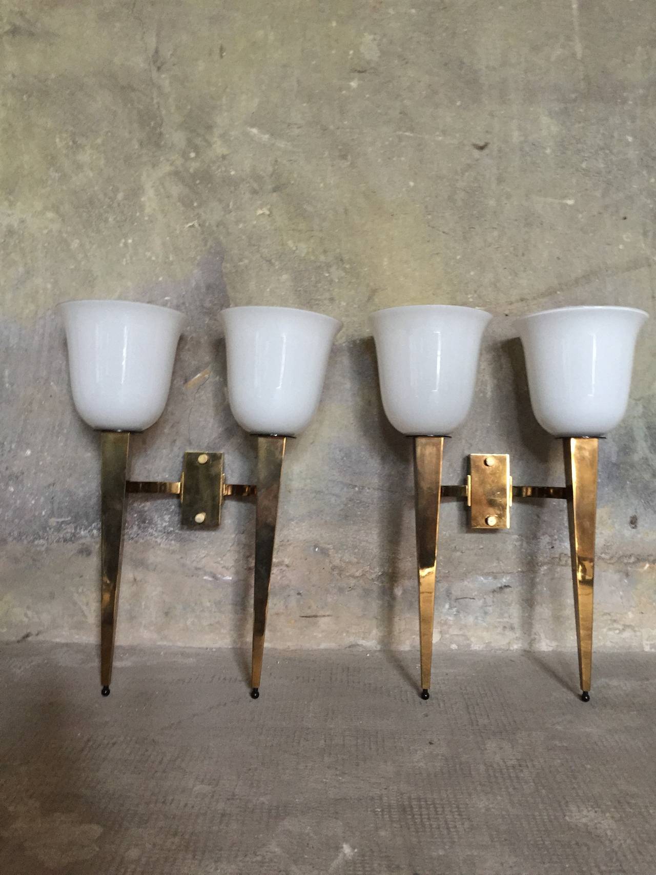 bronze and opaline for this very chic pair of French wall sconces circa 1950

Dim = 47 X 35 X 16 cm