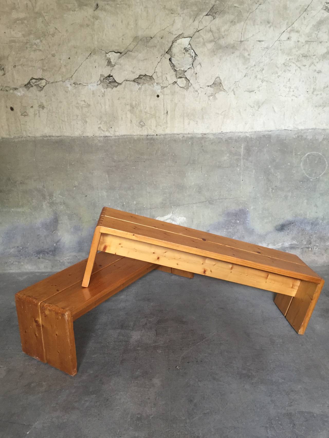 A pair of pine wood benches by Charlotte Perriand for 