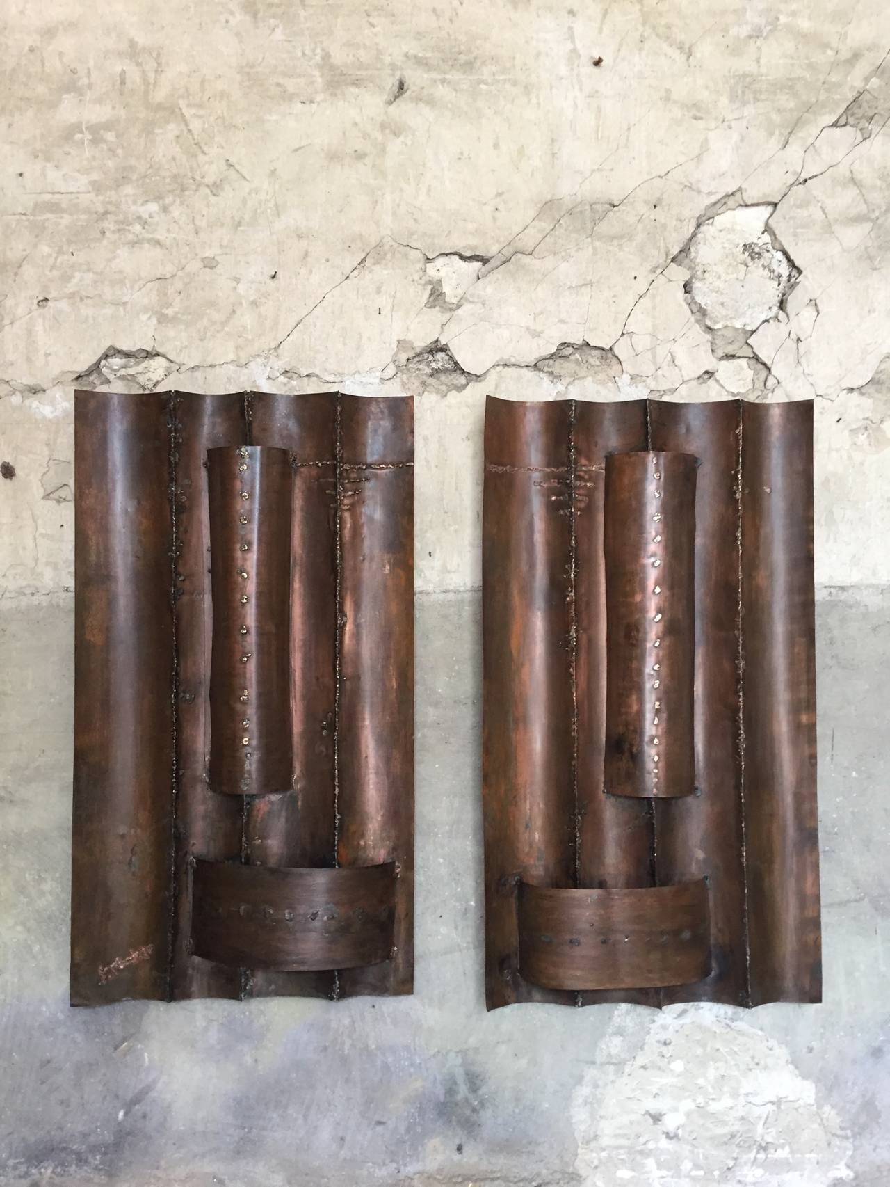 brutalist pair of big copper wall sconces circa 1970

Dim: 108 X 61 X 10 cm