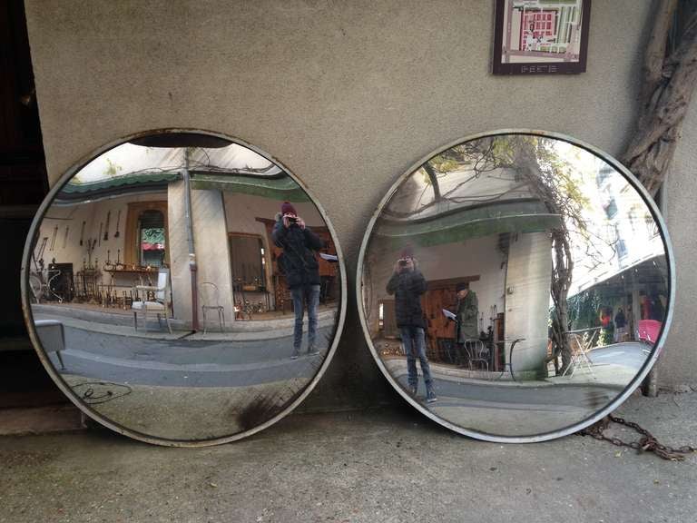 Very spectacular pair of convex mirrors whit metal frame and solid back.  Circa 1930.

Diam = 123 cm