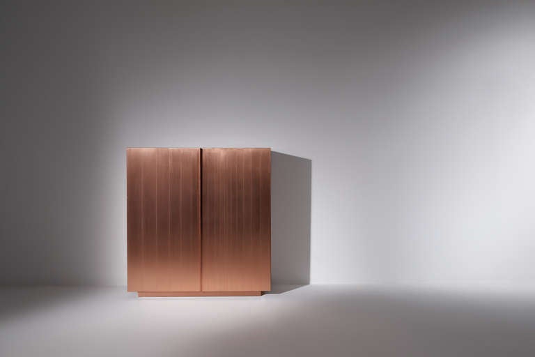 The important italian architects Carlo, Paolo and Anna Bertoli,  create a two door sideboard, covered in copper.
Prototyp accompanied by a certification.
Bertolli Sideboard made of teak. Carved doors and sides fitted with one drawer  each.