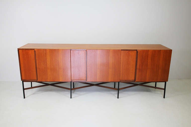 Sideboard, Italy, circa 1960

teak, solid wood handles, wood legs black 
lacquered, cross strives plywood