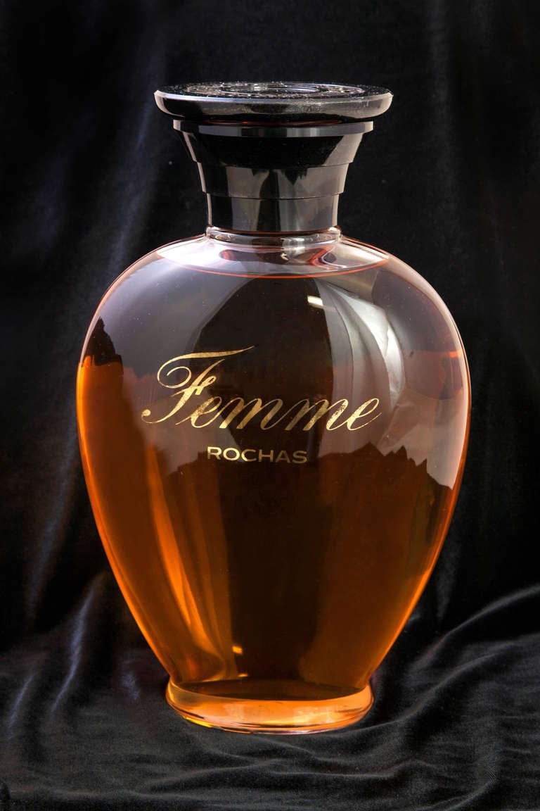 Large perfume factices Tocade and Femme Rochas (Rochas Woman). Each is a collection piece and was originally issued for exclusive use in a French perfumery when a new perfume was launched. 
Measures: Rochas Femme 12 inches H x 4 inches D x 7 inches