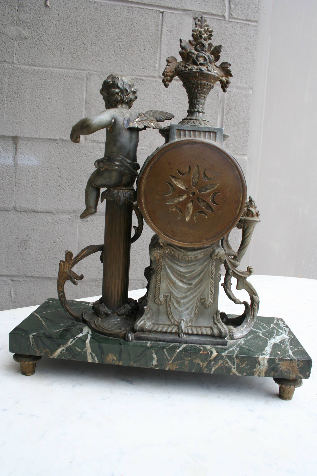 French Bronze and Onyx Mantle Clock Featuring Cherub and Bouquet