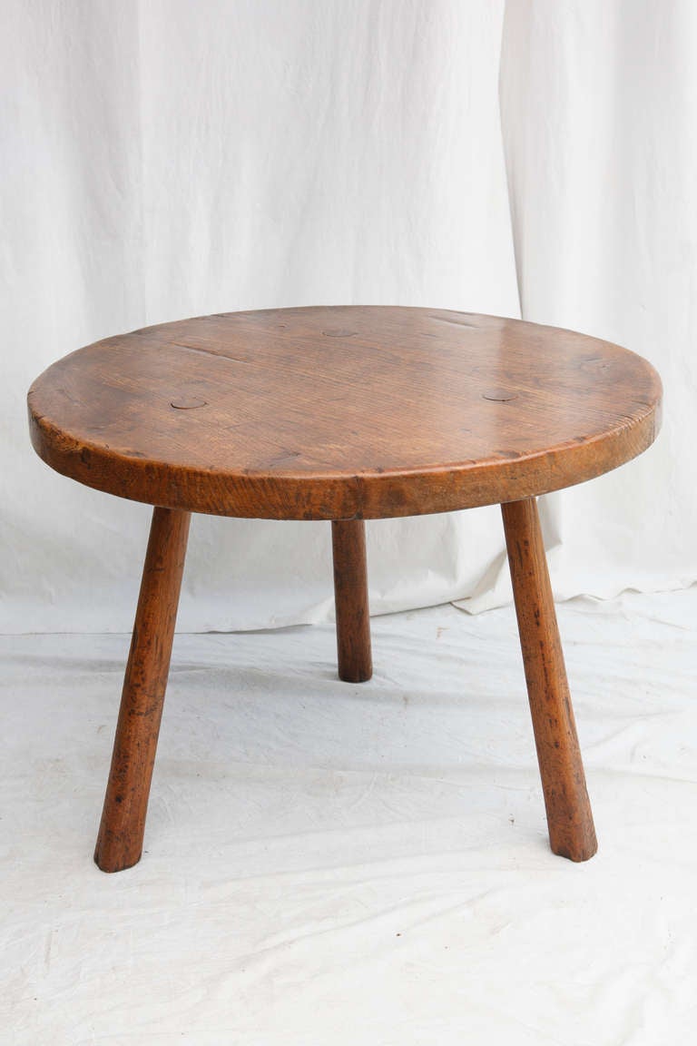 This nineteenth century Spanish oak brasserie table has three legs which are pegged through its impressive 40