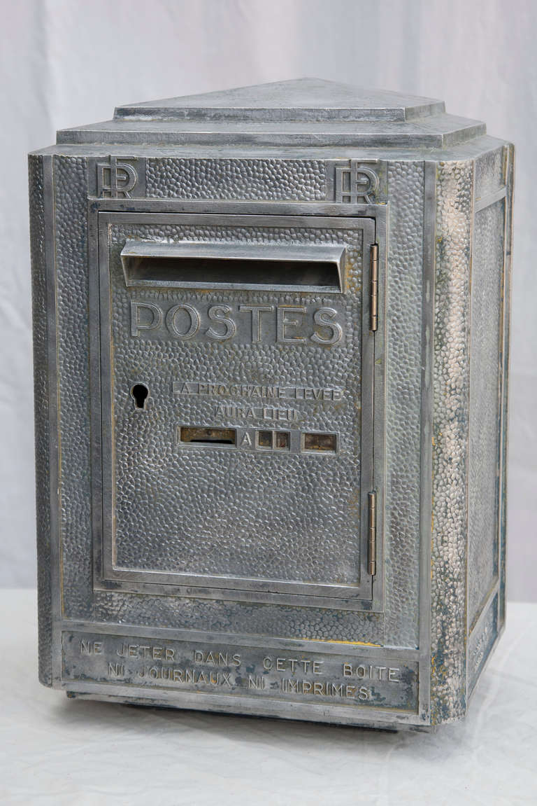 This aluminum boite aux lettres, or mailbox, is fully functional with letter slot and door.  A traditional French mailbox marked Postes, this large box could also make a great decorative object or case for small treasures.