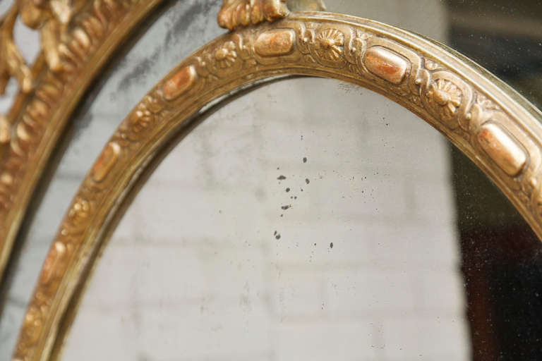 Gold Leaf Grand French Napoleon III Period Louis XVI Style Mirror with Ornate Torch and Arrow Carving