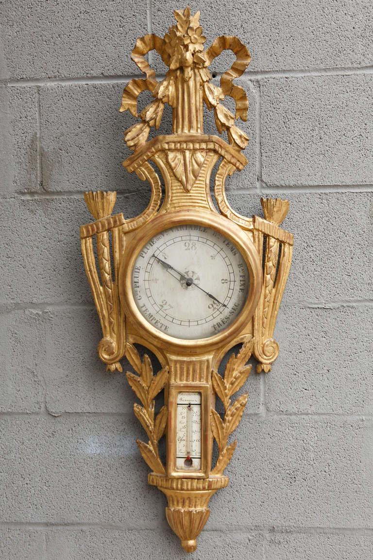 This Louis XVI period gilt barometer has its original hand painted face, glass, and delicate ribbon crown intact.  From the Chateau de Silly near Argentan in Normandy, France, the beautifully carved details and gilt surface have been well preserved.