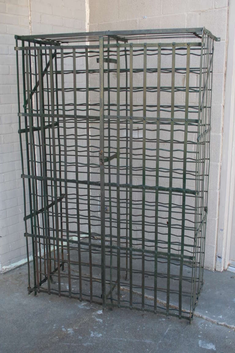 Riveted iron wine cage, c. 1900. Holds 300 bottles and may be attached to the wall. Was originally in the wine cellar of a restaurant in Normandy.