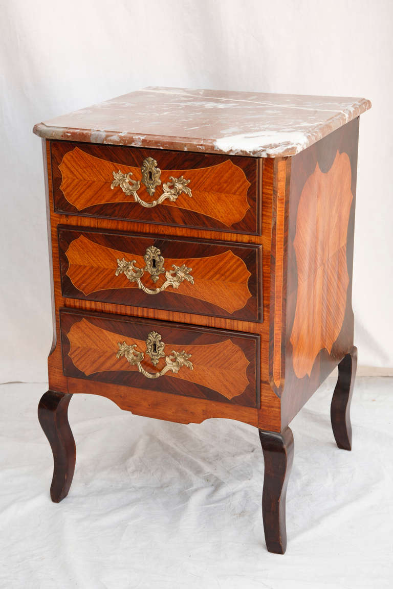 This small scale eighteenth century Louis XV-Louis XVI transition period marquetry chest was originally used to hold the sterling silver in the dining room of a French chateau.  Rosewood and kingwood inlay with gilt bronze fittings and original