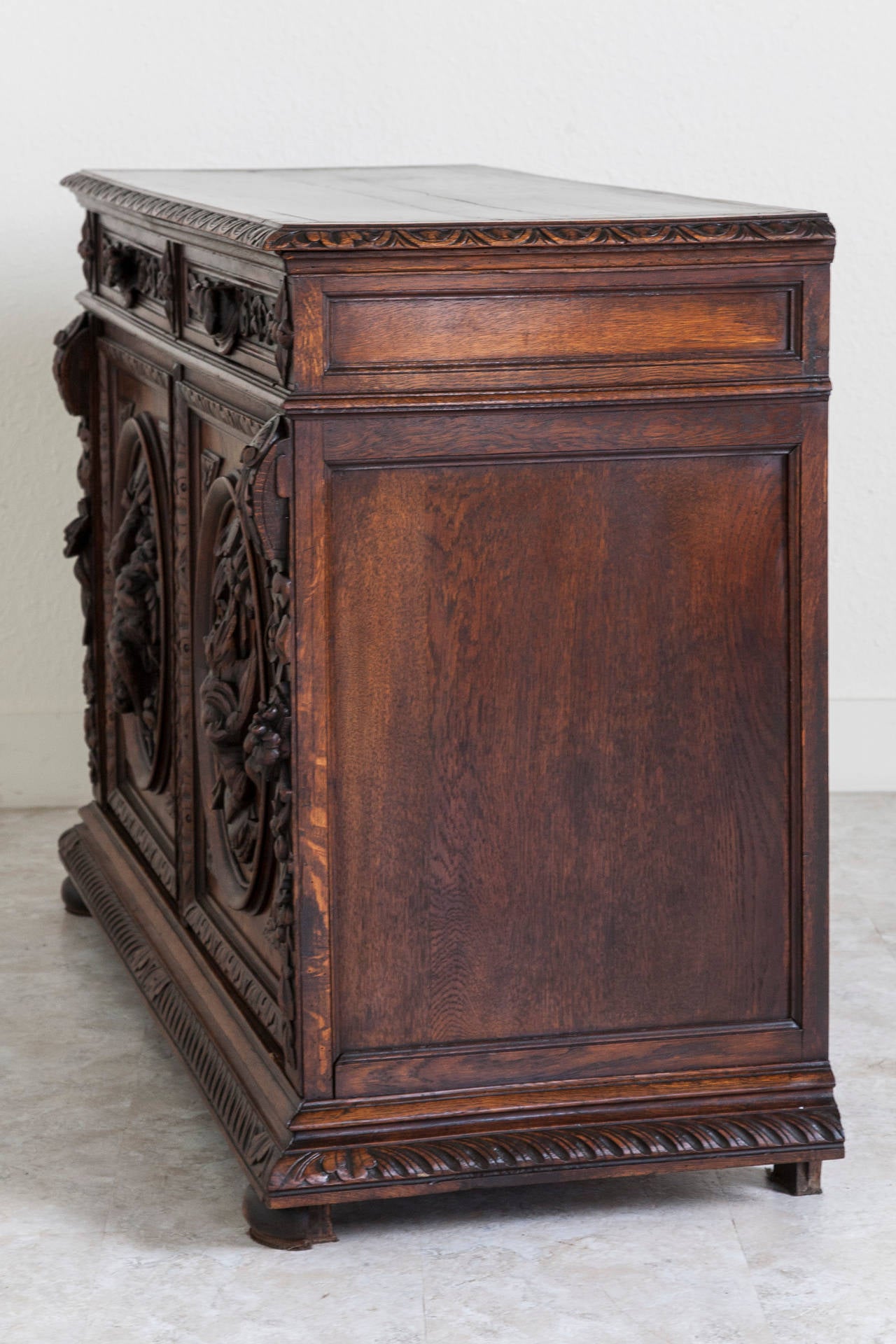 An incredible piece of work by a French artisan, this hand-carved oak Henri II style hunt buffet features wild hare, game birds, fruits and nuts. Behind the deep relief on its doors this piece has a wide open cabinet space with central shelf. Its