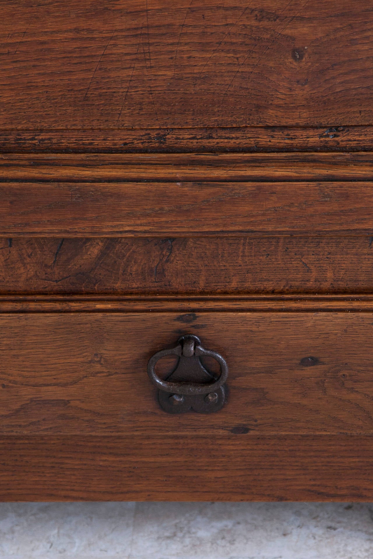 This Louis XIV period oak bonnetière has the incredible warmth that only age can bring. While the Sun King was building his famous chateau at Versailles, the Normandy artisans were adapting the symmetrical Louis XIV style to practical pieces to be