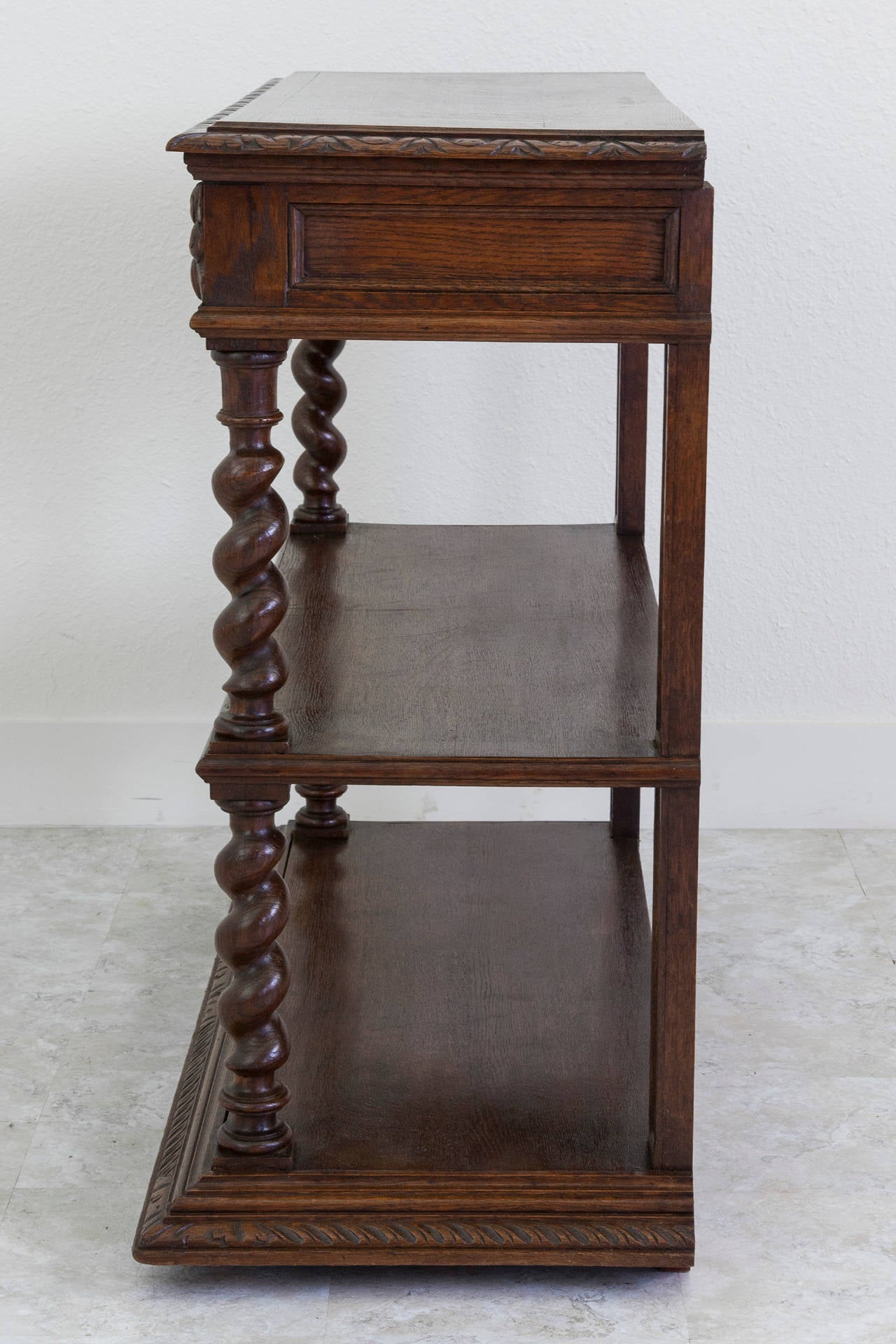 This hand-carved oak Louis XIII style dessert buffet features barley twist legs and two drawers with oak leaf and acorn carvings, circa 1880. Its gadrooned beveled edge top lifts up to reveal a Carrara marble surface originally used for preparing