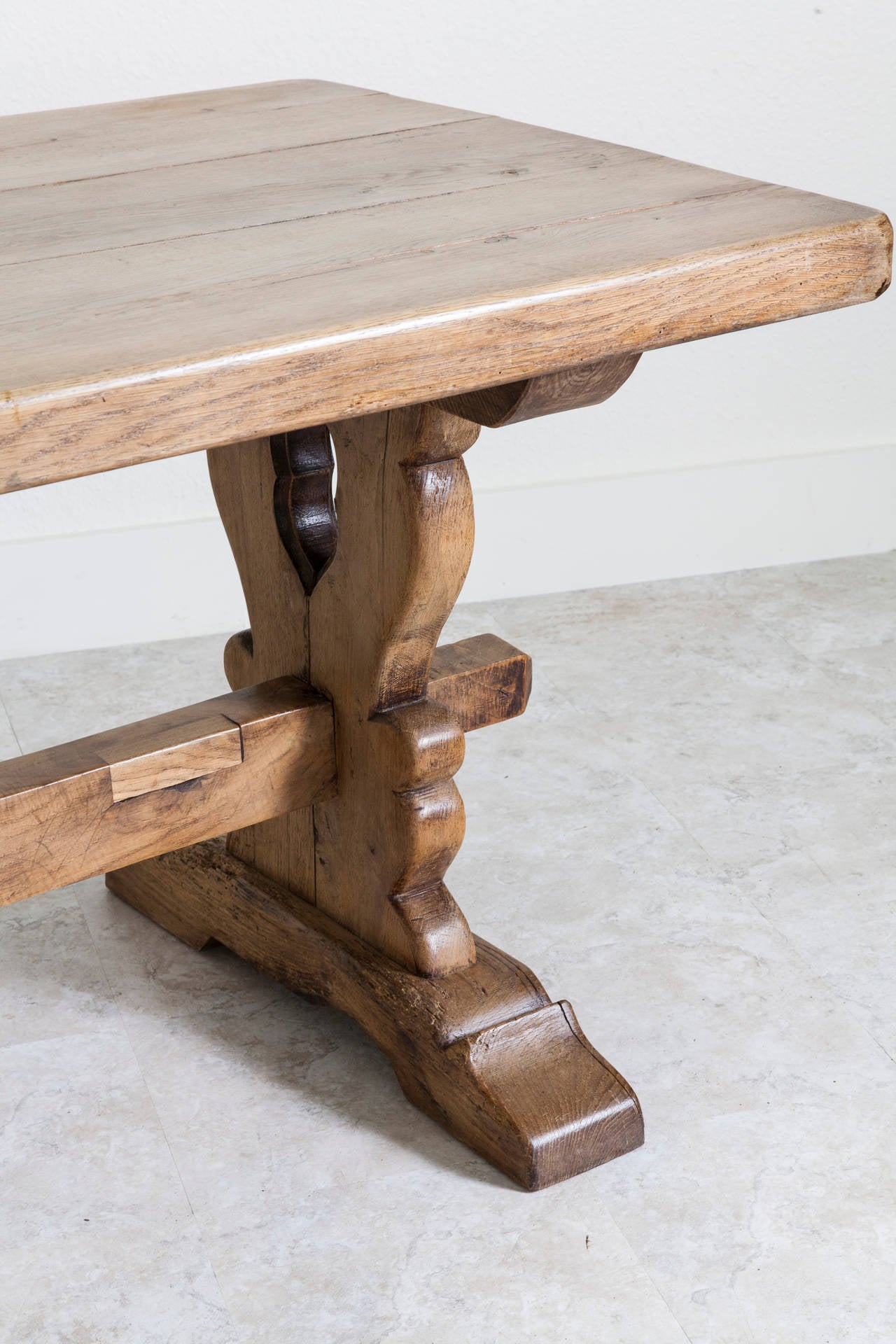 Created by artisans in Normandy, this solid French oak table has an aged light oak, almost cerused patina and handsome lines. With hand-cut 3