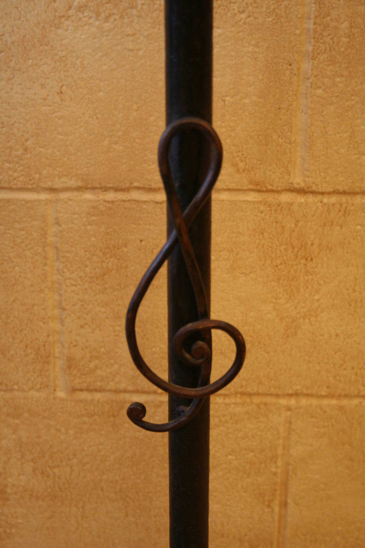This artisan made iron music stand features two candleholders designed to light one's sheets of music. Accented by a gold tipped treble clef, this will make a wonderful decorative piece for any music lover, and a useful accessory for any musician.