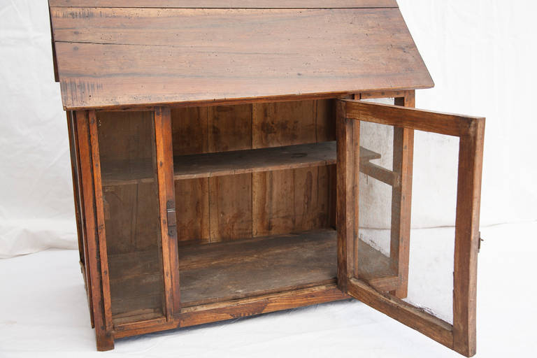 This 19th century artisan-made wooden garde manger or food safe is from Normandy, France and takes on the form of a house. Originally used to store meats, cheeses and vegetables, it contains a single shelf and is enclosed with wire mesh. Its single