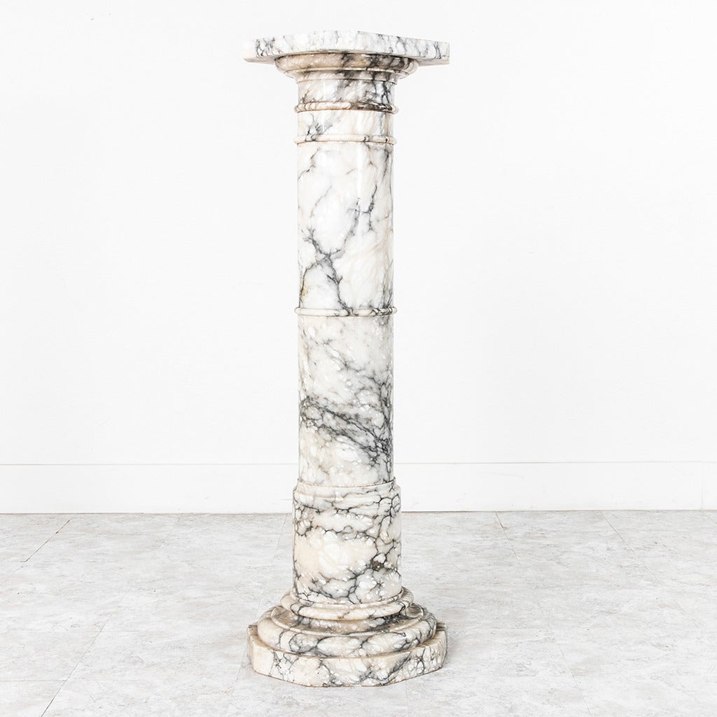 This late 19th century French marble pedestal makes a grand statement. At nearly four feet in height, any item displayed on top of it will bee seen at eye level. A substantial display surface of just over one foot will allow large arrangements or