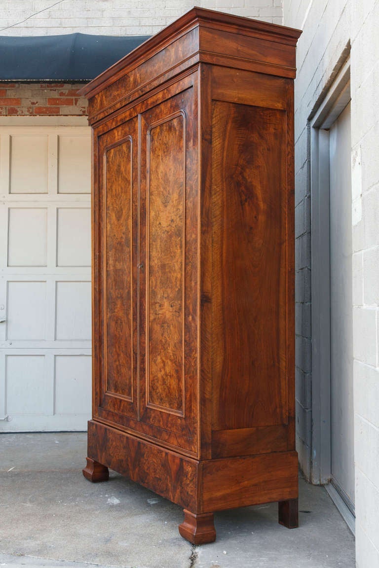 Book matched burled walnut nineteenth century Louis Philippe armoire with lower drawer. Has one interior shelf and can accommodate additional shelves.