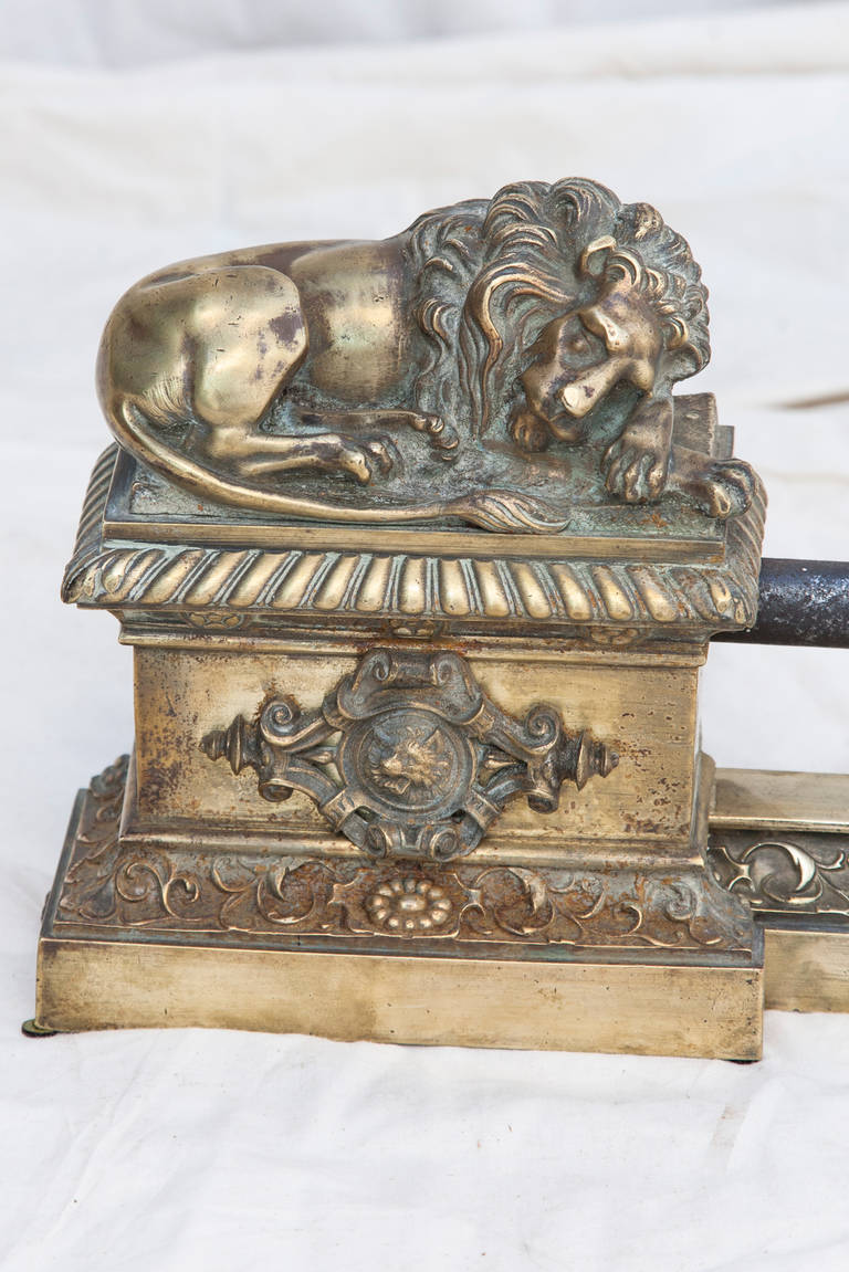 This Napoleon III period bronze fireplace fender features two lions, each with his unique recumbent pose. They are resting on pedestals adorned with heraldic crests. Adjustable length of 40.5