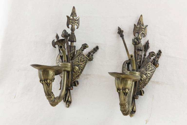 This impressive pair of nineteenth century bronze sconces with medieval weapons were originally used as gas lights in a large home in Granville, France.  Their rare masculine and refined look would blend beautifully in a man's study or den.  For