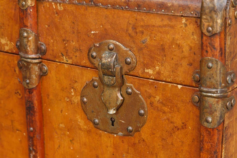 This leather trunk with wood strapping and brass trim is marked Algiers, c. 1900. It originally belonged to a Frenchman in colonial Algeria and has traveled well, giving the leather a beautiful patina.  Some minor scratches and wear consistent with