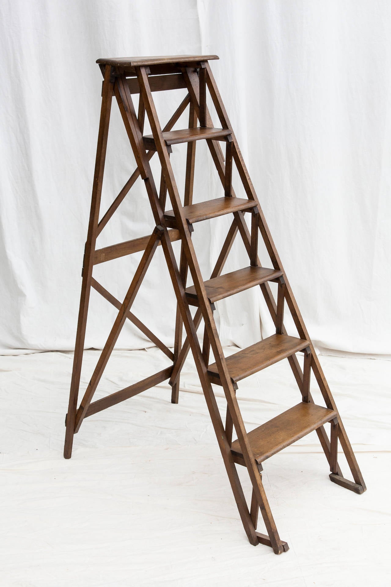 This artisan-made library ladder is a functioning piece ready for a home office or library and would also make a charming display piece with the steps serving as shelves. Beech, circa 1940.