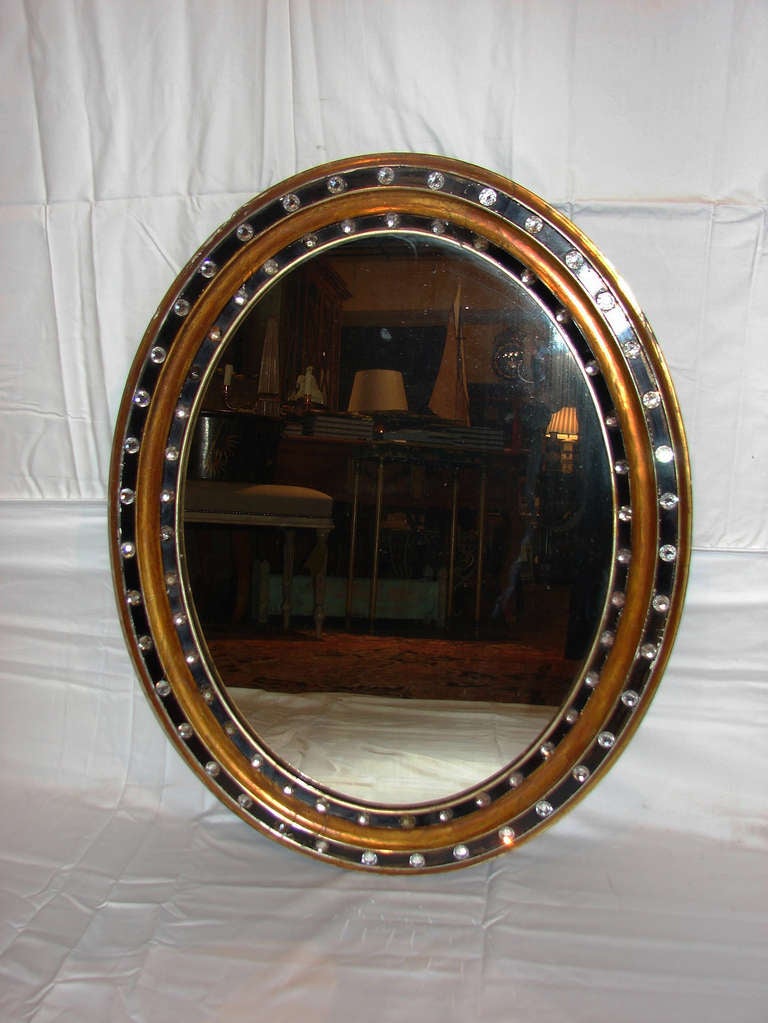 Attractive, 19th century Irish oval gilt and black painted wood  mirror with two bands of faceted glass studs.