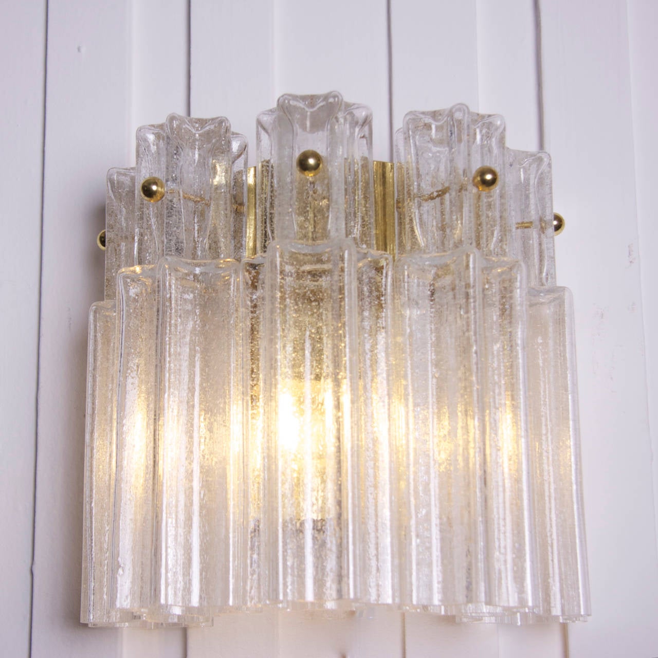 Rare Limburg sconces in brass and glass in excellent condition, in the Venini style. These lamps came out of a German casino that was renovated in the 1960s with these beautiful lamps.
Also three chandeliers from the same series available in another