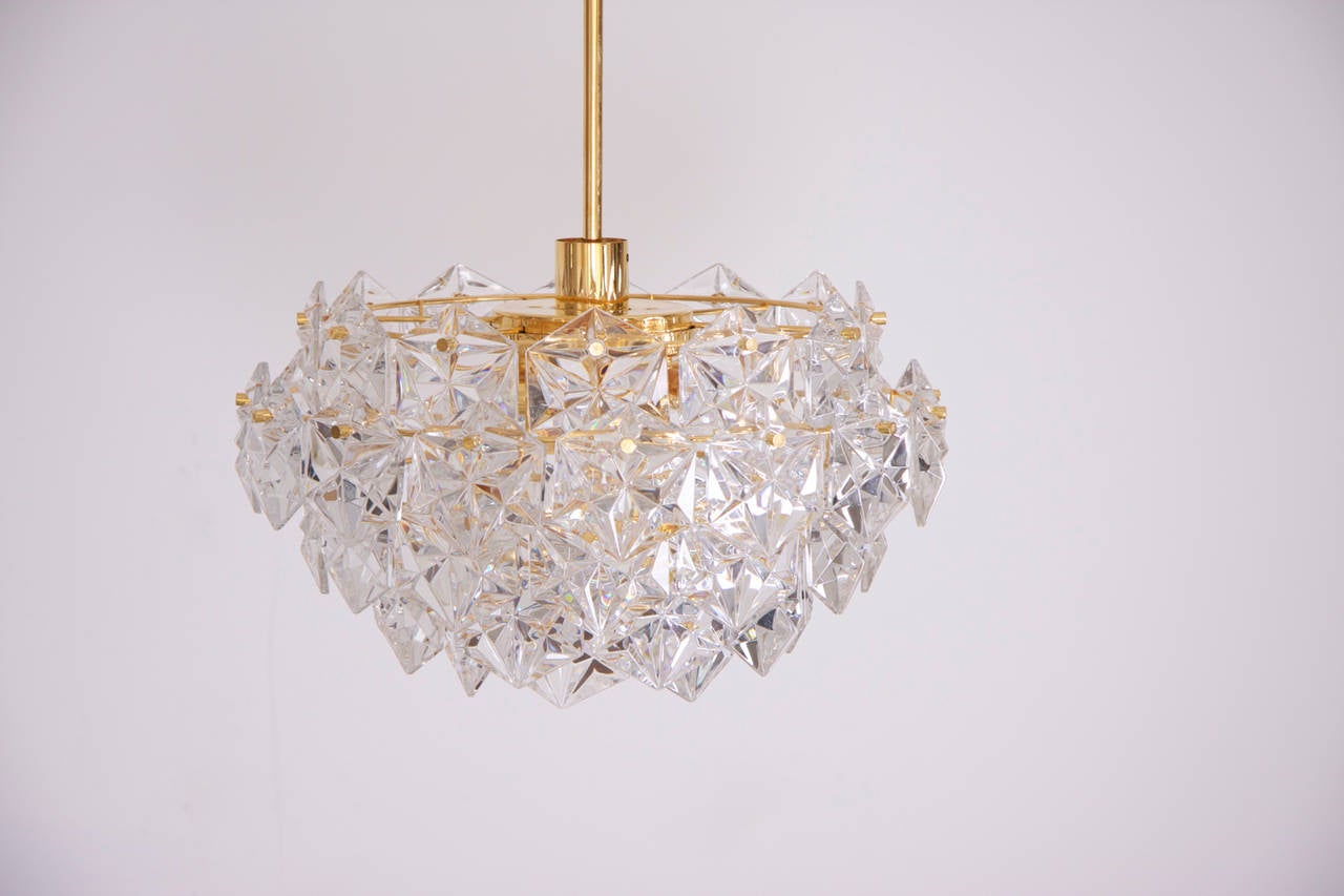 Stunning four-tier chandelier by Kinkeldey with huge gem-like crystals and gold-plated brass frame.
