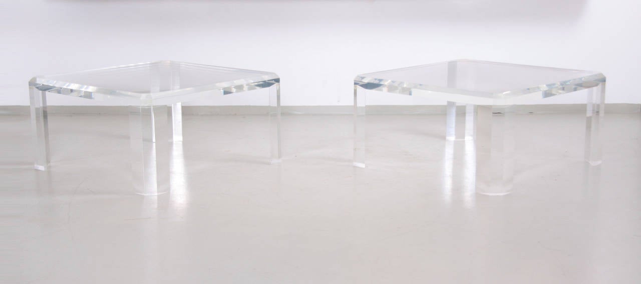 Glamorous pair of Hollywood Regency coffee tables. 

Tables are made of massive Lucite and they can be used as coffee tables or side tables.

