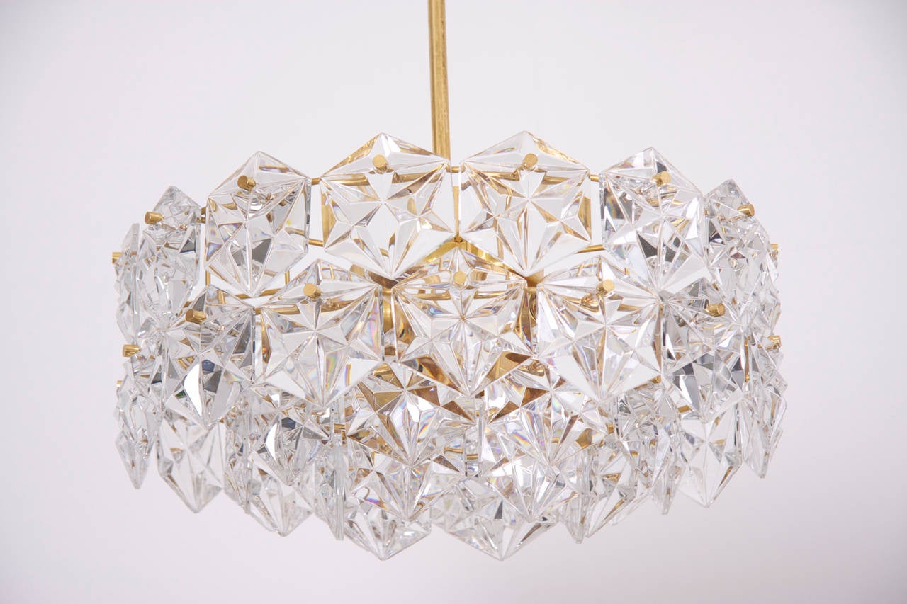 Stunning four-tier chandelier by Kinkeldey with huge gem-like crystals and gold-plated brass frame. Chandelier ist fitted with 6 E14 bulbs and 1 E27 bulb.

More stunning Kinkeldey chandeliers in other sizes and forms are listed.

To be on the the