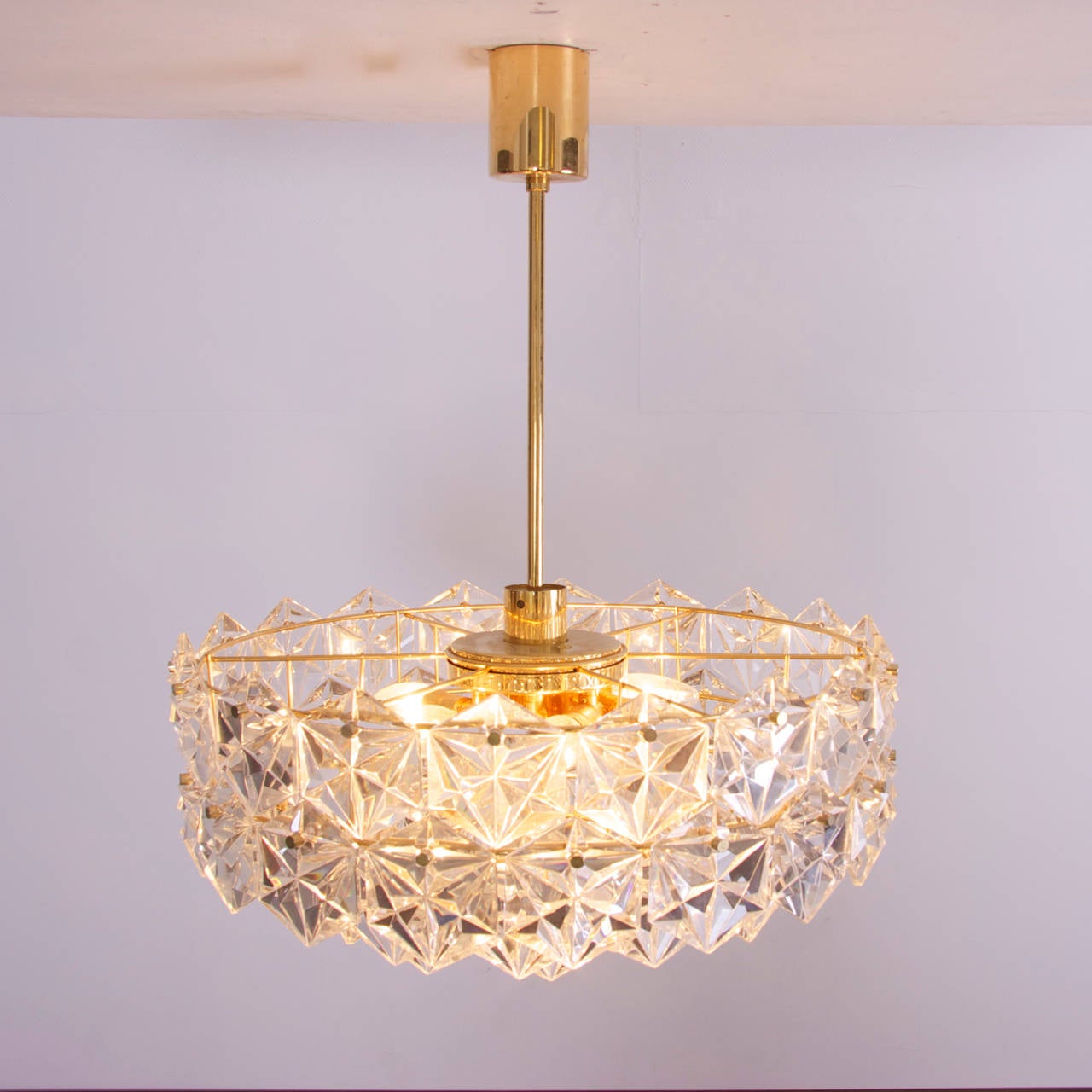 Stunning, large four-tier chandelier by Kinkeldey with huge gem-like crystals and gold-plated brass frame. Chandelier is fitted with six E14 bulbs and one E27 bulb.

More stunning Kinkeldey chandeliers in other sizes and forms and wall lamps are