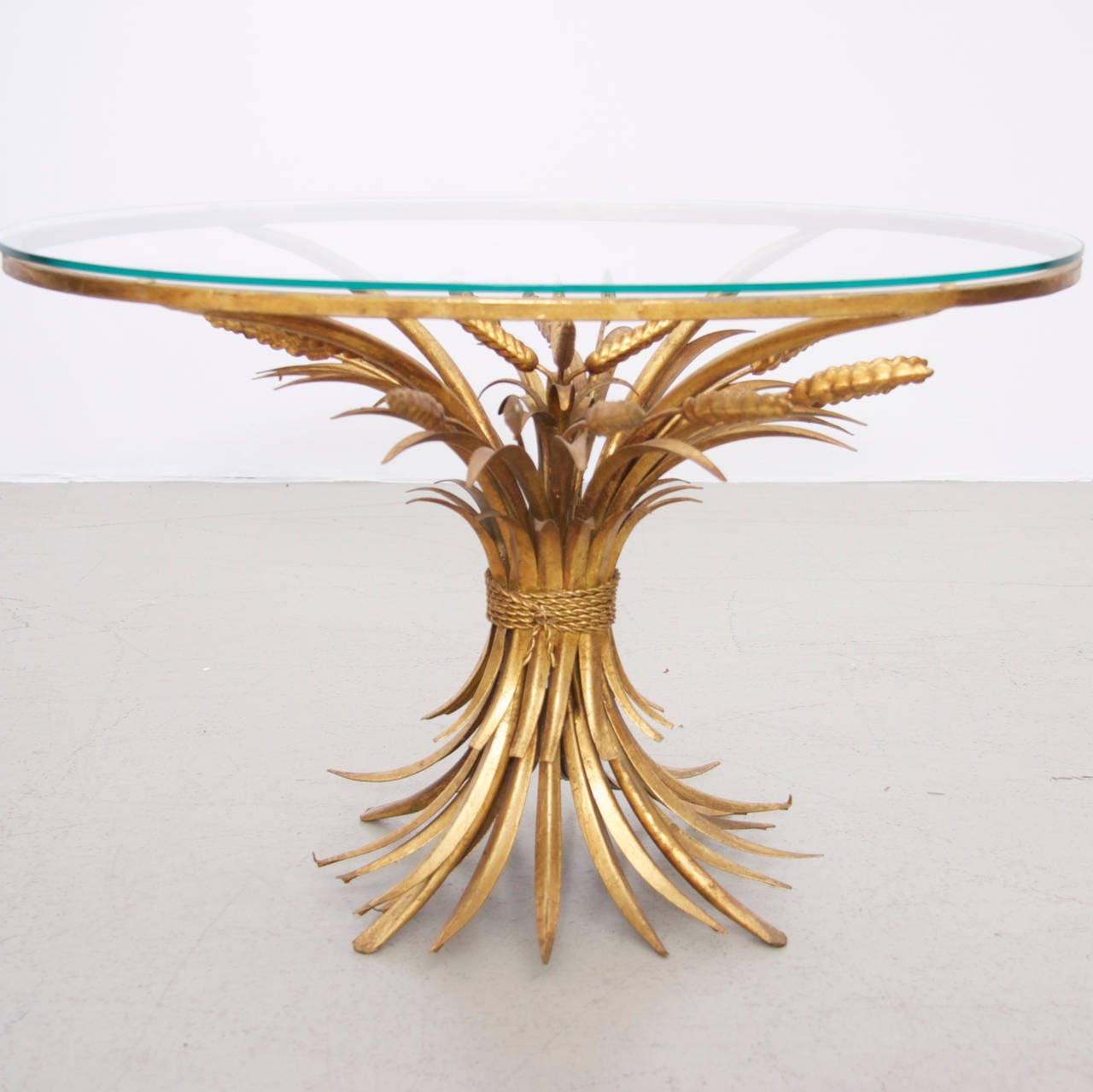 Wunderful gilt metal side table in the form of a sheaf of wheat. This tables were used by Coco Chanel in her wonderful apartment. This Coco Chanel table is special compared to the others listed here, because the table top has a gilt metal frame,