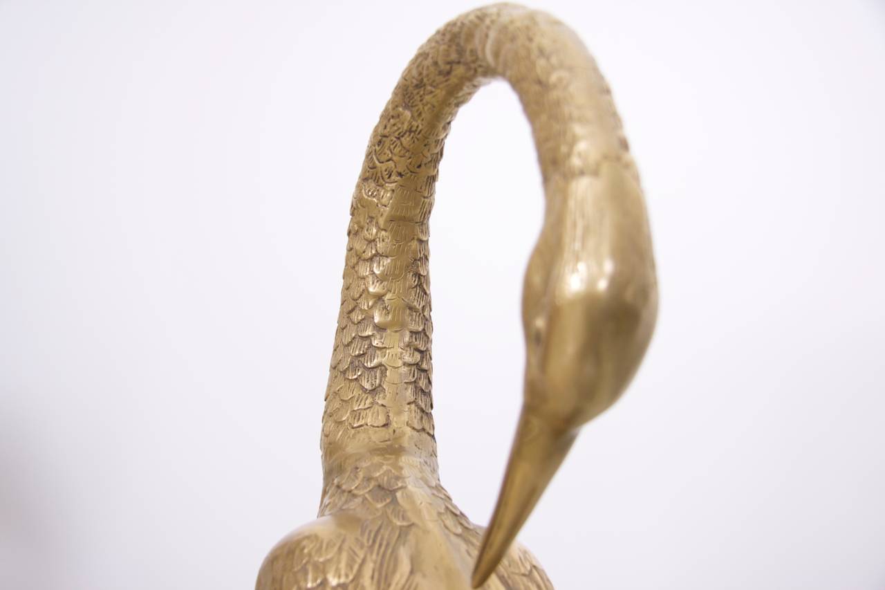 Extraordinary huge pair of flamingos or cranes made of brass. They are in very good condition and they bring the Hollywood regency glamour in every room.