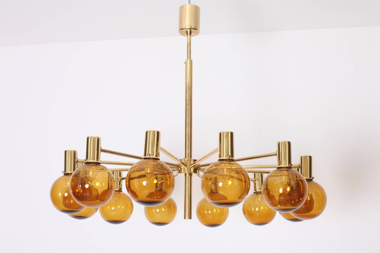 Very huge, rare ceiling lamp or chandelier in brass with smoked glass bowls. The chandelierhas 12 brass arms with glass bowls. It is designed by Hans-Agne Jakobsson and produced by AB Markaryd, Sweden. This beautiful and very rare chandelier is