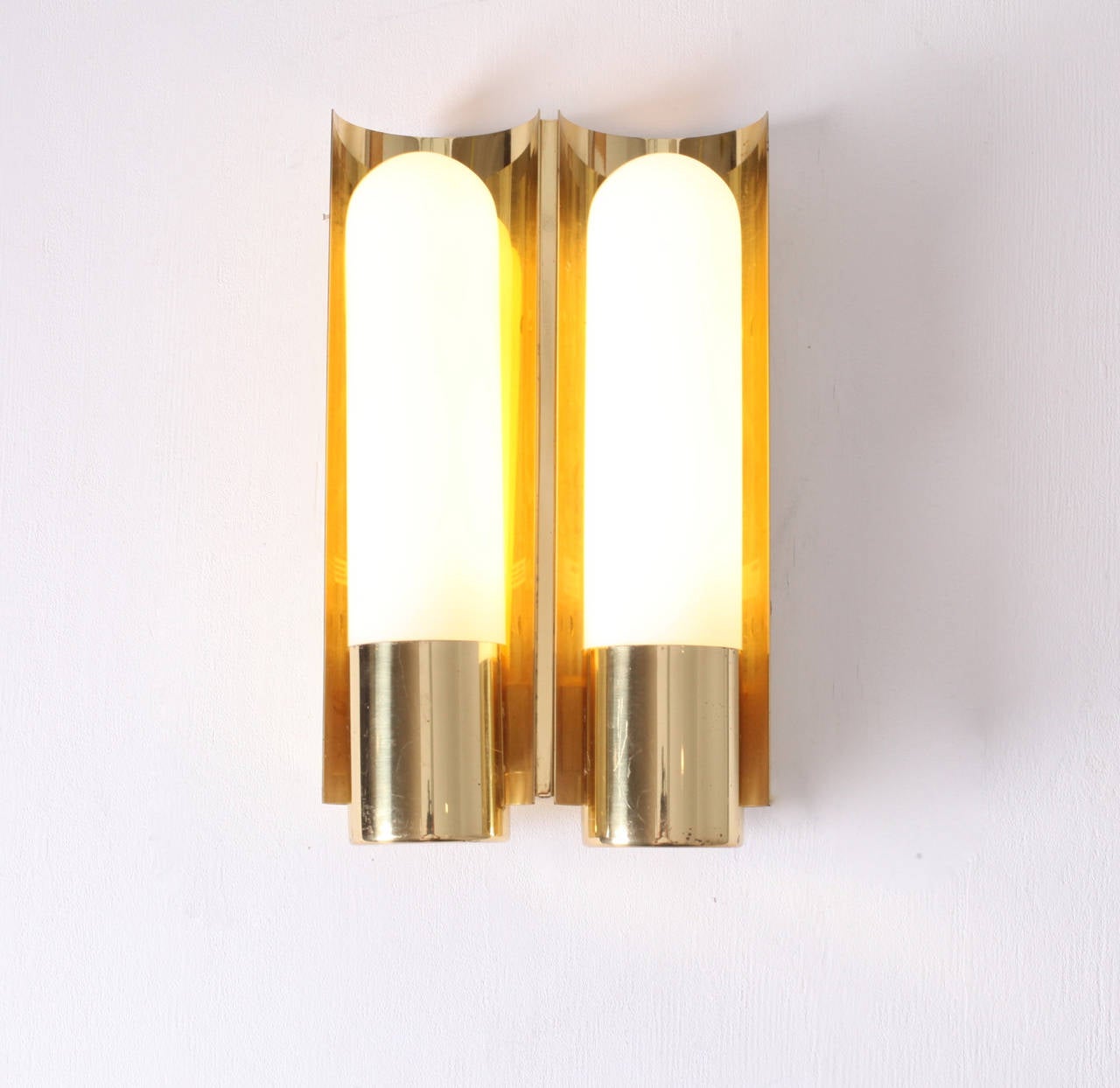 Beautiful  glass and brass wall lights. We have another Listing with a pair of the single version of this model. 2xL11W/42
To be on the the safe side, the lamp should be checked locally by a specialist concerning local requirements.
