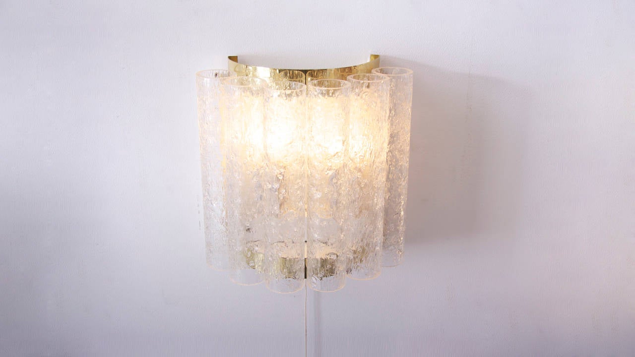 Wonderful pair off high-end Doria wall lamps.Manufactered in the sixties. Metal structure with brass details, heavy glasspipes which creates a great atmosphere when lit. 2x E14 each lamp.
To be on the the safe side, the lamp should be checked