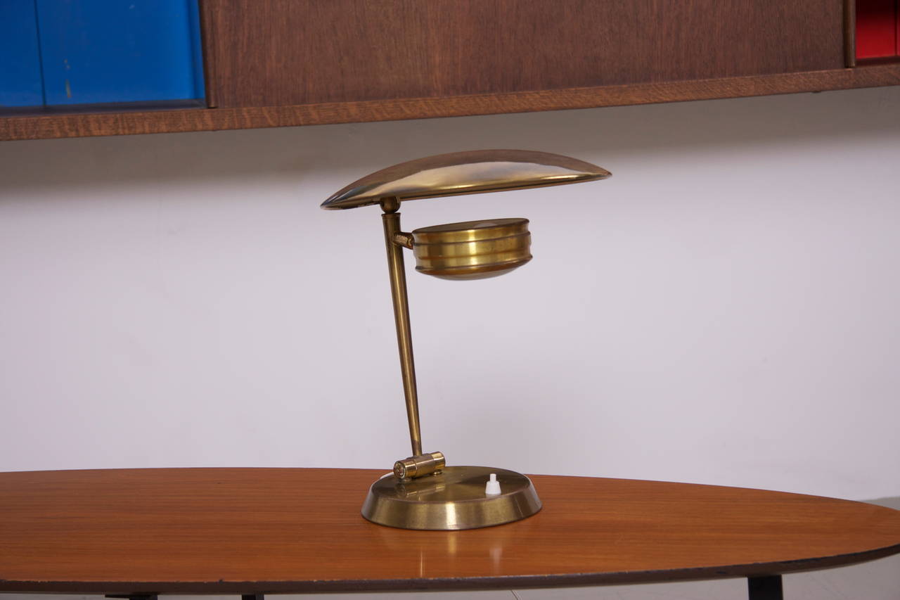 Nice 1950s brass glass table lamp produced in Italy. Very heay base, swivel arm and shade in brass metal with original glass diffuser. 1 x E14 fitting. small dents on top