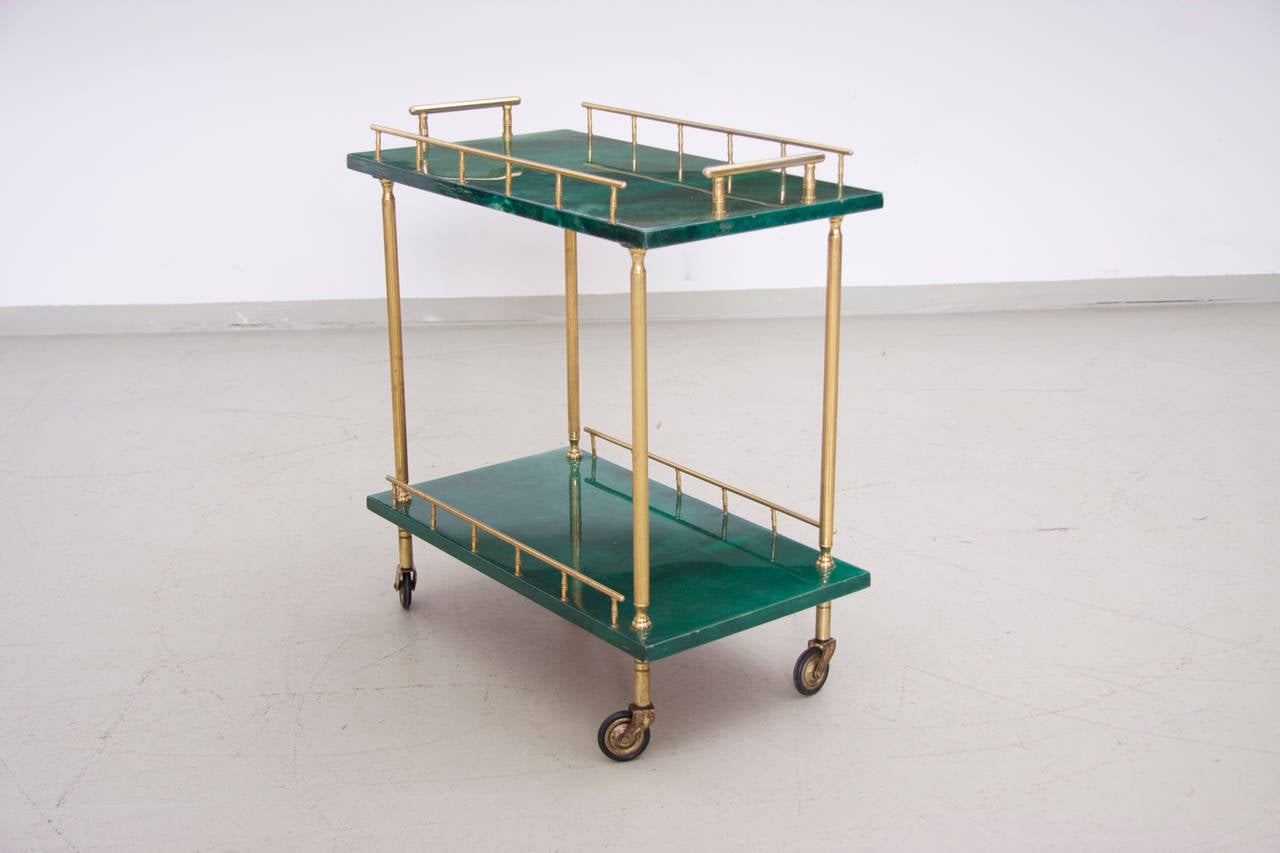Very nice and decorative tea cart by Aldo Tura for Tura, Italy, 1950. This goat skin covered tea cart has a very nice green color with brass-plated metal details and rubber wheels.
The cart is in very good condition, the wheels work perfectly as