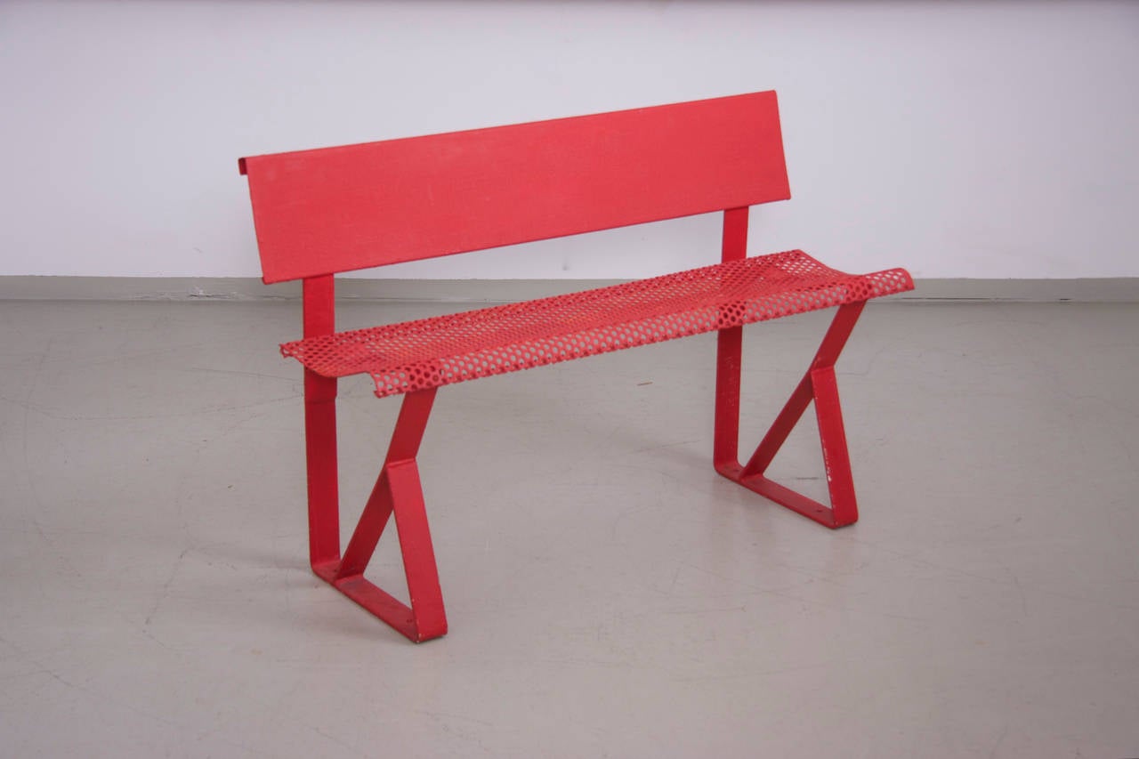 Industrial kids bench in red painted metal from the 1960s.

