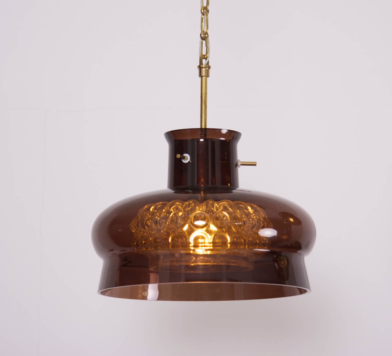 Glass pendant by Carl Fagerlund for Orrefors, Sweden. Double glass shades on brass chain.

