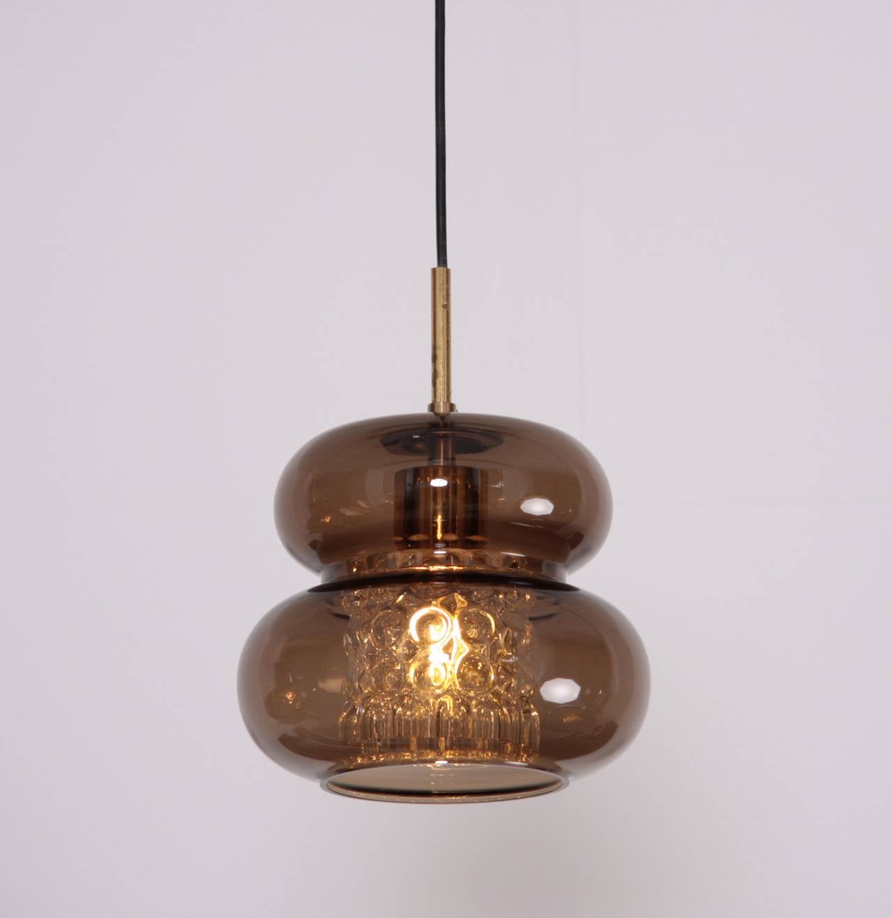 Pendant by Carl Fagerlund for Orrefors with pressed glass diffuser in a brown glass shade.

