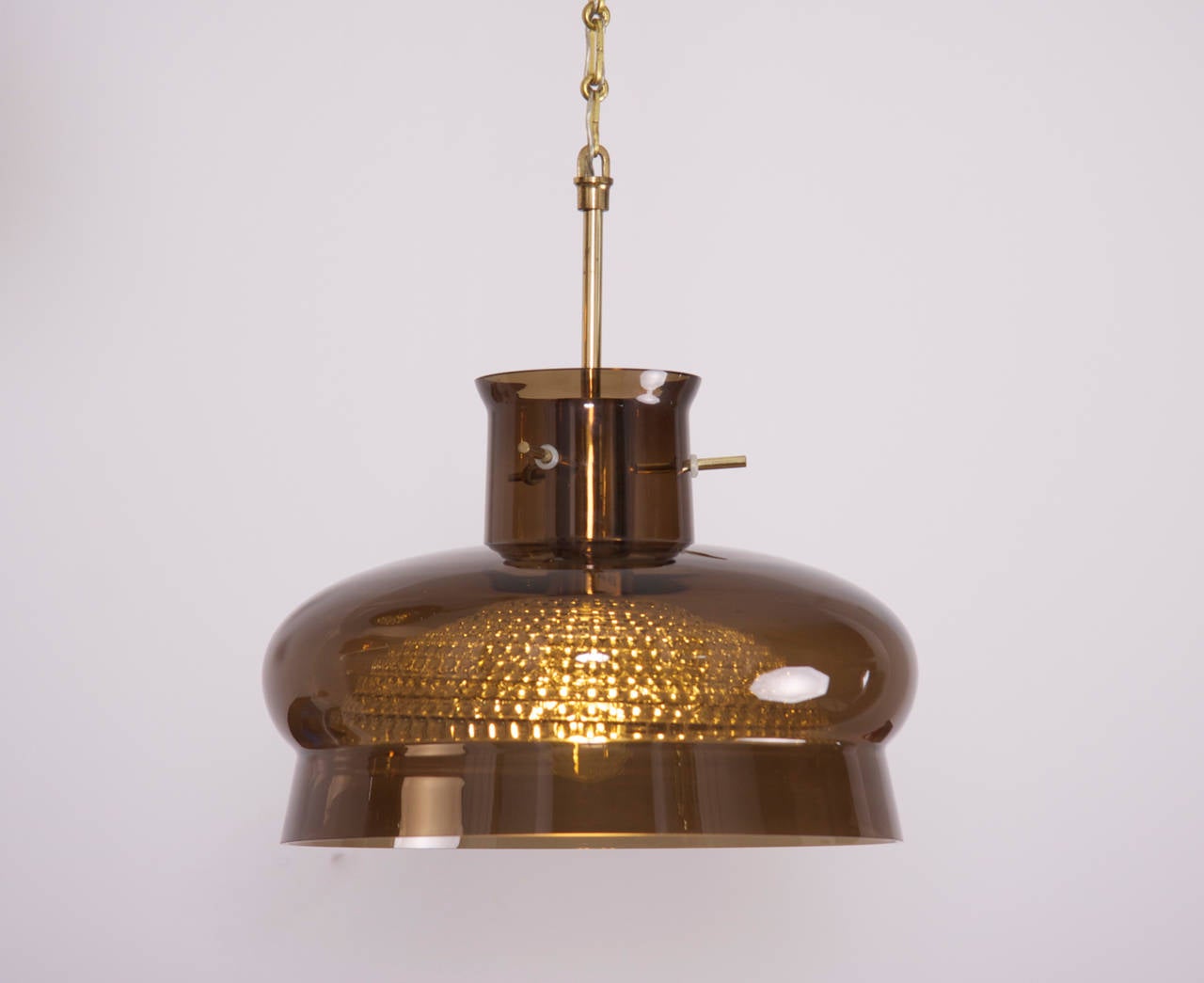 Glass pendant by Carl Fagerlund for Orrefors, Sweden. Double glass shades on brass chain.
To be on the the safe side, the lamp should be checked locally by a specialist concerning local requirements.
