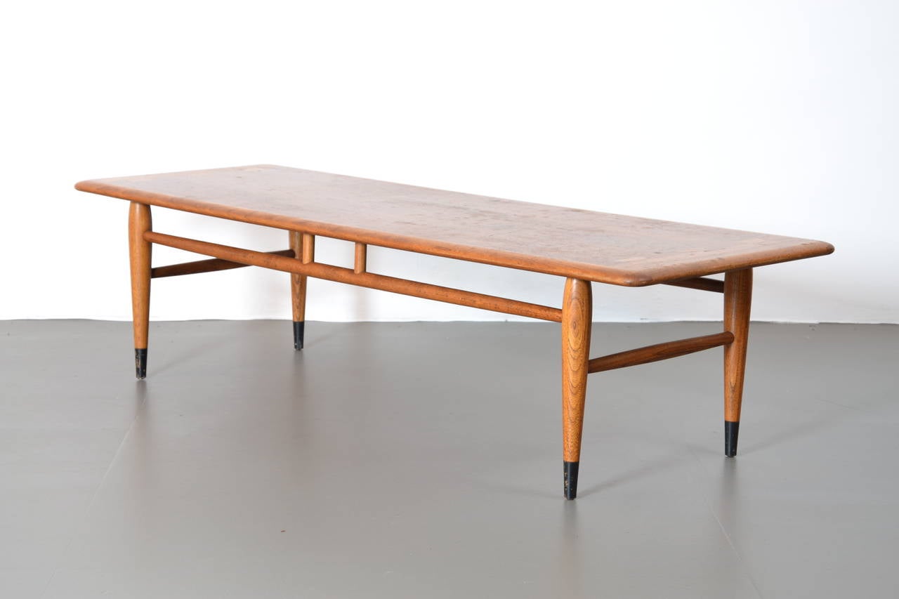 Beautiful midcentury coffee table manufactured by Lane - Altavista Virginia in high quality craftsmanship. Using two kinds of wood supports the attractive design. The table is in good condition.